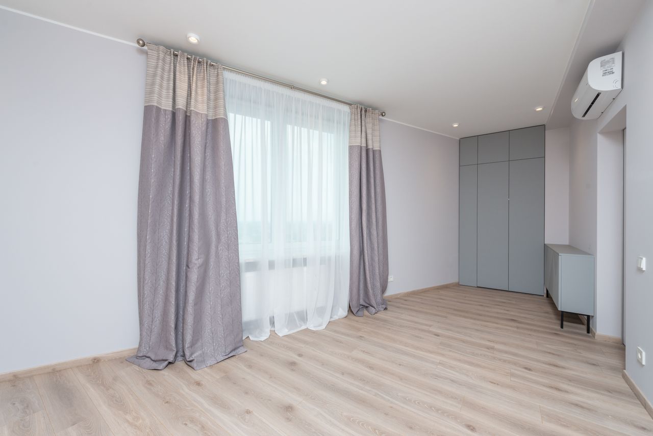 Modern room interior with cabinet and closet on floor under air conditioning and lamps in light house
